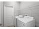 Well-equipped laundry room with modern washer, dryer, and convenient shelving at 12950 Sw 38Th Cir, Ocala, FL 34473