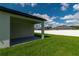 This backyard patio space has a painted concrete floor and features covered space to sit in the shade at 12950 Sw 38Th Cir, Ocala, FL 34473