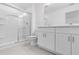 Contemporary bathroom featuring a glass-enclosed shower, dual sink vanity, and tile flooring at 172 River Front Way, Edgewater, FL 32141