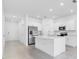 A well lit, all-white kitchen featuring stainless steel appliances and a functional island at 172 River Front Way, Edgewater, FL 32141