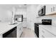 Well-lit kitchen with quartz countertops and stainless steel appliances at 172 River Front Way, Edgewater, FL 32141
