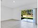 Bright living room featuring tile floors and large sliding glass doors to the backyard at 172 River Front Way, Edgewater, FL 32141