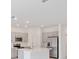Modern kitchen with stainless steel appliances, gray cabinets, and a quartz island at 174 River Front Way, Edgewater, FL 32141