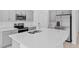 Modern kitchen features stainless appliances, a large island, and gray cabinets at 174 River Front Way, Edgewater, FL 32141