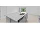 Kitchen island with stainless steel sink and light gray cabinets at 174 River Front Way, Edgewater, FL 32141
