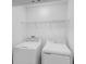 Laundry room features white front load washer and dryer at 174 River Front Way, Edgewater, FL 32141