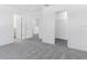 Spacious bedroom with carpeted floors, multiple doorways, and a walk-in closet providing ample space at 176 River Front Way, Edgewater, FL 32141