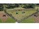 Well-equipped and enclosed dog park featuring play structures, benches, and green space at 176 River Front Way, Edgewater, FL 32141