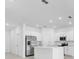 Bright kitchen with stainless steel appliances, white cabinets and a large center island at 176 River Front Way, Edgewater, FL 32141
