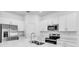 Bright, modern kitchen with stainless steel appliances, microwave, and white cabinets at 176 River Front Way, Edgewater, FL 32141