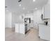 Modern kitchen features a large center island, stainless appliances, and white cabinets at 176 River Front Way, Edgewater, FL 32141