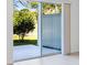 Bright sliding glass doors offer seamless transition to the outdoor patio and lush backyard scenery at 176 River Front Way, Edgewater, FL 32141