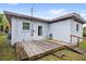 This backyard features a wooden deck and a charming home exterior at 1825 Baldwin Dr, Orlando, FL 32806
