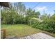 Spacious backyard with a small wood deck and established landscaping at 1825 Baldwin Dr, Orlando, FL 32806