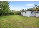 Backyard featuring a large grassy area and the exterior of the home at 1825 Baldwin Dr, Orlando, FL 32806