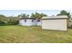 Backyard featuring the exterior of the home and a storage shed at 1825 Baldwin Dr, Orlando, FL 32806