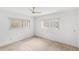 Minimalist bedroom with neutral walls and carpet, featuring windows that bring in ample light at 1825 Baldwin Dr, Orlando, FL 32806