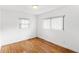 Bright bedroom featuring hardwood floors, natural light, and freshly painted white walls at 1825 Baldwin Dr, Orlando, FL 32806