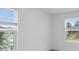 Bright bedroom featuring ample natural light streaming through large windows with modern blinds at 184 River Front Way, Edgewater, FL 32141