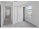Cozy bedroom with a closet, a window bringing natural light, and neutral-toned carpet flooring at 184 River Front Way, Edgewater, FL 32141