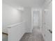 Well-lit upstairs hallway featuring neutral-toned walls, carpet, and recessed lighting at 184 River Front Way, Edgewater, FL 32141