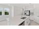 Bright kitchen featuring a large island with white cabinets and stainless steel appliances at 184 River Front Way, Edgewater, FL 32141