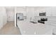Bright kitchen featuring a large island, stainless steel appliances, and white cabinets at 184 River Front Way, Edgewater, FL 32141