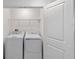 Clean and efficient laundry room with washer, dryer, and storage space at 184 River Front Way, Edgewater, FL 32141