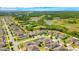 Aerial view of a residential community featuring neatly planned houses, green spaces, and a pool at 256 Whirlaway Dr, Davenport, FL 33837