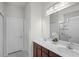 Bathroom with double sink vanity, quartz countertop and decorative white flowers at 256 Whirlaway Dr, Davenport, FL 33837