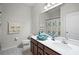 Bright bathroom featuring a single sink vanity with white countertop and decorative ocean-themed accents at 256 Whirlaway Dr, Davenport, FL 33837