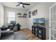Brightly lit bedroom has decorative shelving and a sofa at 256 Whirlaway Dr, Davenport, FL 33837