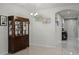 Chandelier and decorative cabinet in neutral colored dining room at 256 Whirlaway Dr, Davenport, FL 33837