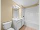 Bathroom featuring a single vanity, a toilet, and a shower-tub combo with a white shower curtain at 8316 Quimby Cir, Davenport, FL 33896