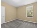 Bright bedroom with plush carpeting, neutral walls, and a window that lets in natural light at 8316 Quimby Cir, Davenport, FL 33896