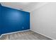 Empty bedroom featuring blue accent wall, gray carpet and neutral colored walls at 8316 Quimby Cir, Davenport, FL 33896