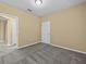 Cozy bedroom with plush carpeting and a view of adjacent rooms through open doorways at 8316 Quimby Cir, Davenport, FL 33896