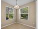 Bright breakfast nook features tile flooring and two large windows with views of the outdoors at 8316 Quimby Cir, Davenport, FL 33896