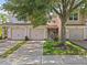 Charming townhome with attached garages and well-maintained landscaping showcasing its inviting curb appeal at 8316 Quimby Cir, Davenport, FL 33896