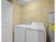 Laundry room with washer, dryer, wire shelving and hot water heater at 8316 Quimby Cir, Davenport, FL 33896