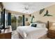Comfortable bedroom with white bedding, ceiling fan, and sliding glass doors to a balcony at 8487 Crystal Cove Loop, Kissimmee, FL 34747