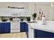 Kitchen featuring updated countertops, modern appliances, and blue and white cabinetry at 8487 Crystal Cove Loop, Kissimmee, FL 34747
