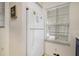 Bright kitchen area featuring a white refrigerator and window with blind at 8487 Crystal Cove Loop, Kissimmee, FL 34747