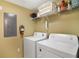 Convenient laundry room equipped with a washer, dryer, and shelf at 8487 Crystal Cove Loop, Kissimmee, FL 34747