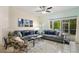Comfortable living room with screened-in porch access, plush seating, and natural light at 8487 Crystal Cove Loop, Kissimmee, FL 34747