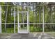 Screened patio with door leading to treed backyard at 8487 Crystal Cove Loop, Kissimmee, FL 34747