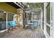Screened patio features seating and wooden deck, perfect for relaxing outdoors at 8487 Crystal Cove Loop, Kissimmee, FL 34747