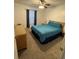 Cozy bedroom featuring a ceiling fan, neutral carpeting, and a large window at 1001 Plantation Dr # A2, Kissimmee, FL 34741