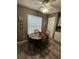 Cozy dining area features a wood table, four chairs, window, and ceiling fan for comfortable meals at 1001 Plantation Dr # A2, Kissimmee, FL 34741