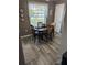 A dining area featuring a wood table, four chairs, a window, and wood-look flooring at 1001 Plantation Dr # A2, Kissimmee, FL 34741